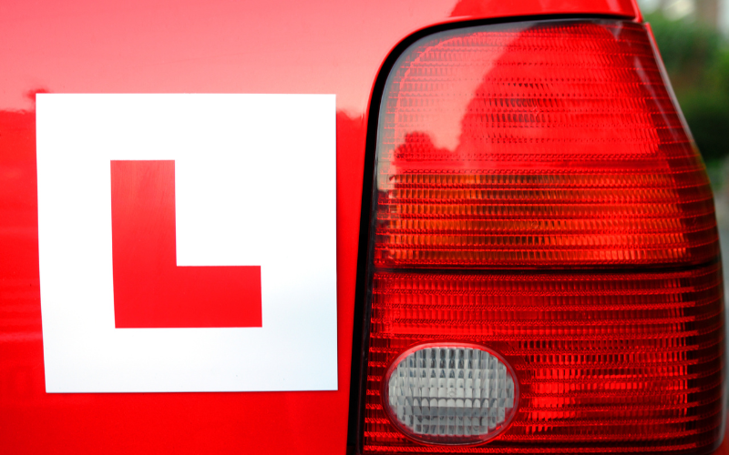 Small car with L plate for a new driver
