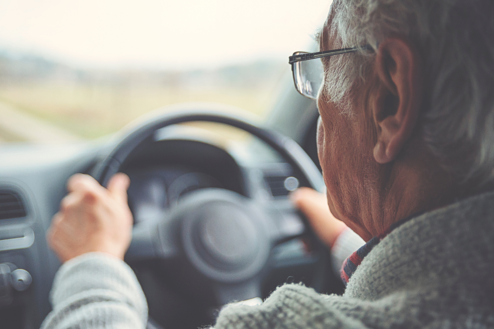 Senior driver in a small used car